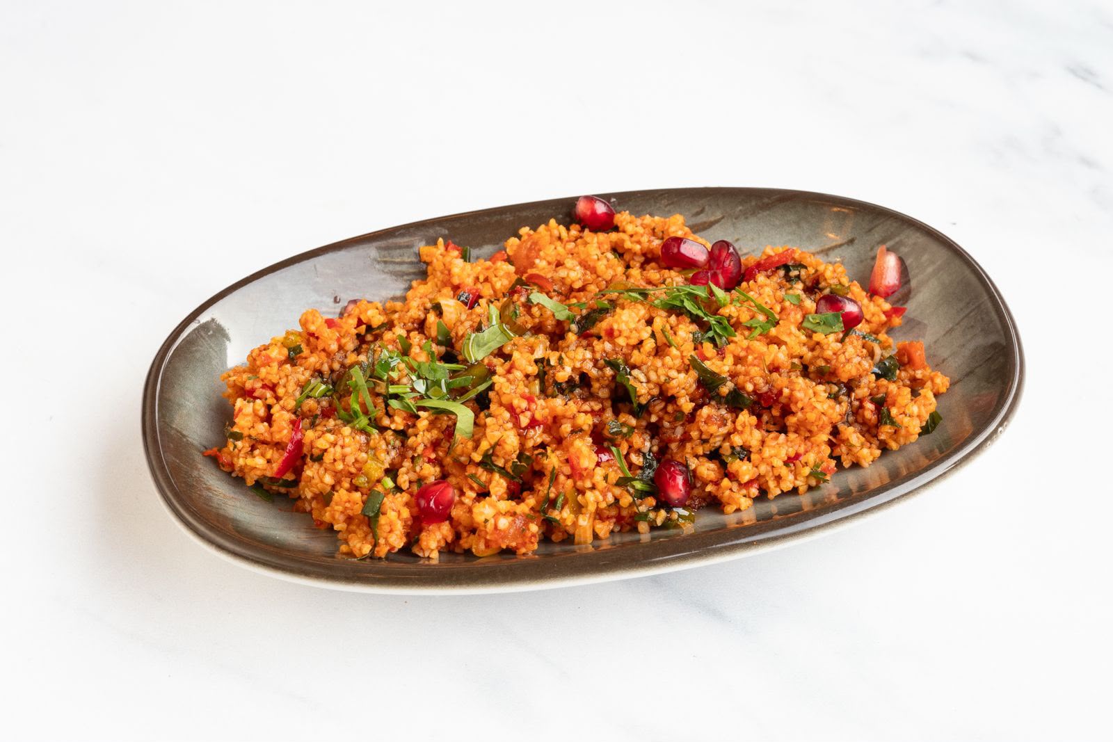Kisir bulgur salad with pomegranate seeds and fresh herbs, a classic cold meze at The Kervan.
