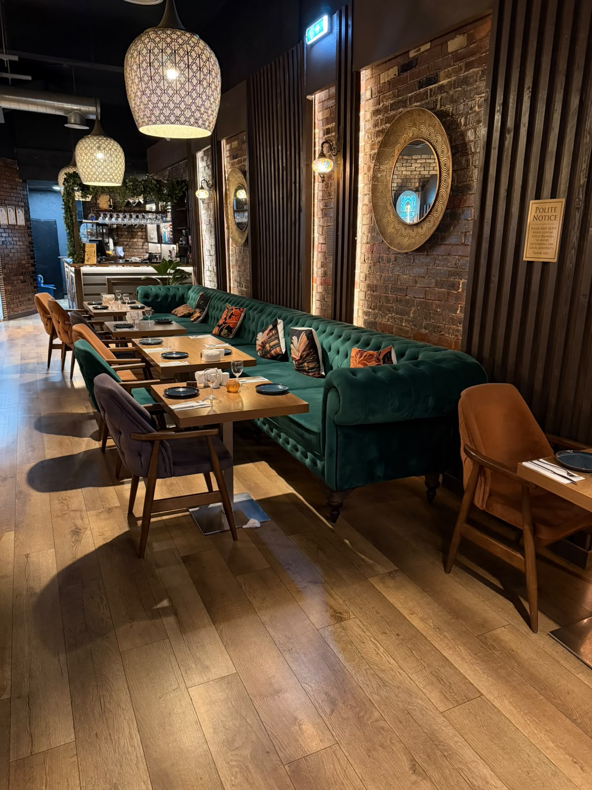 Patterned pendant lanterns and gold mirrors above the dining room and bar at The Kervan.