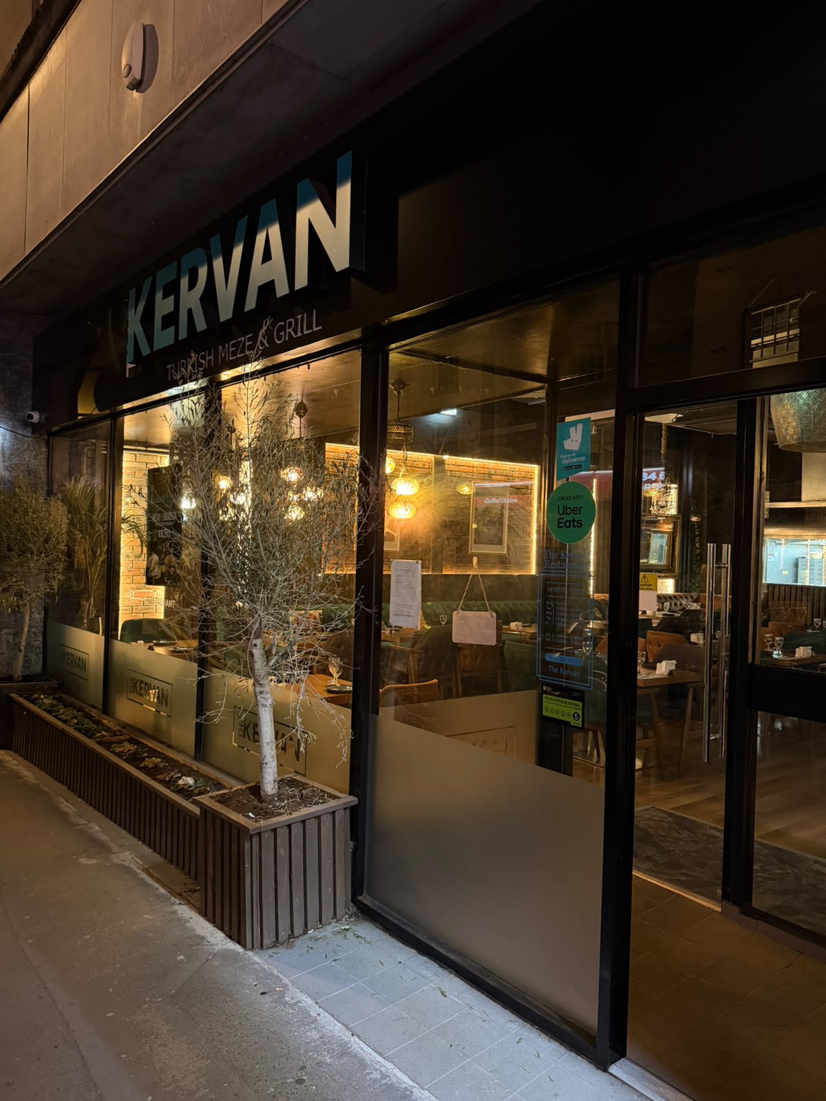 The Kervan Turkish Meze and Grill shopfront on Stourbridge High Street lit up at night